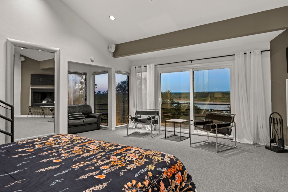 723 Coventry Road Spicewood, TX 78669 - Photo 14 of 40 a bedroom with furniture and large windows