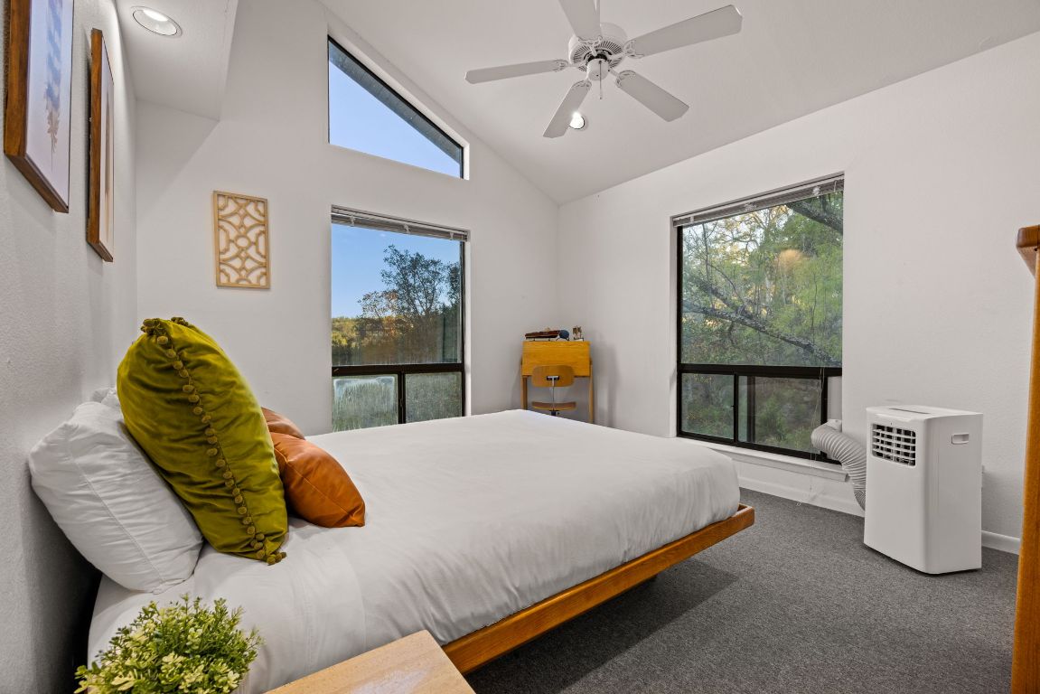 723 Coventry Road Spicewood, TX 78669 - Photo 18 of 40 a bedroom with a large bed and a window