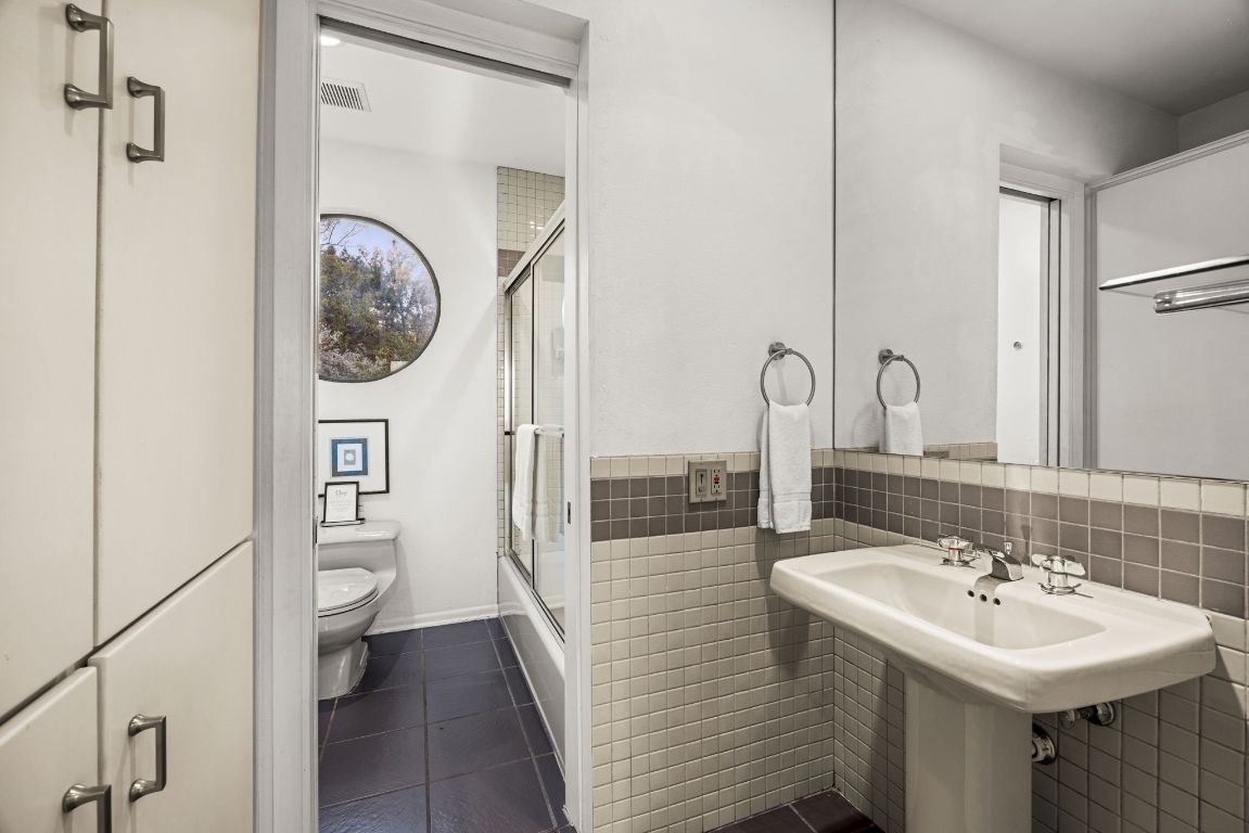 723 Coventry Road Spicewood, TX 78669 - Photo 21 of 40 a bathroom with a sink toilet and shower