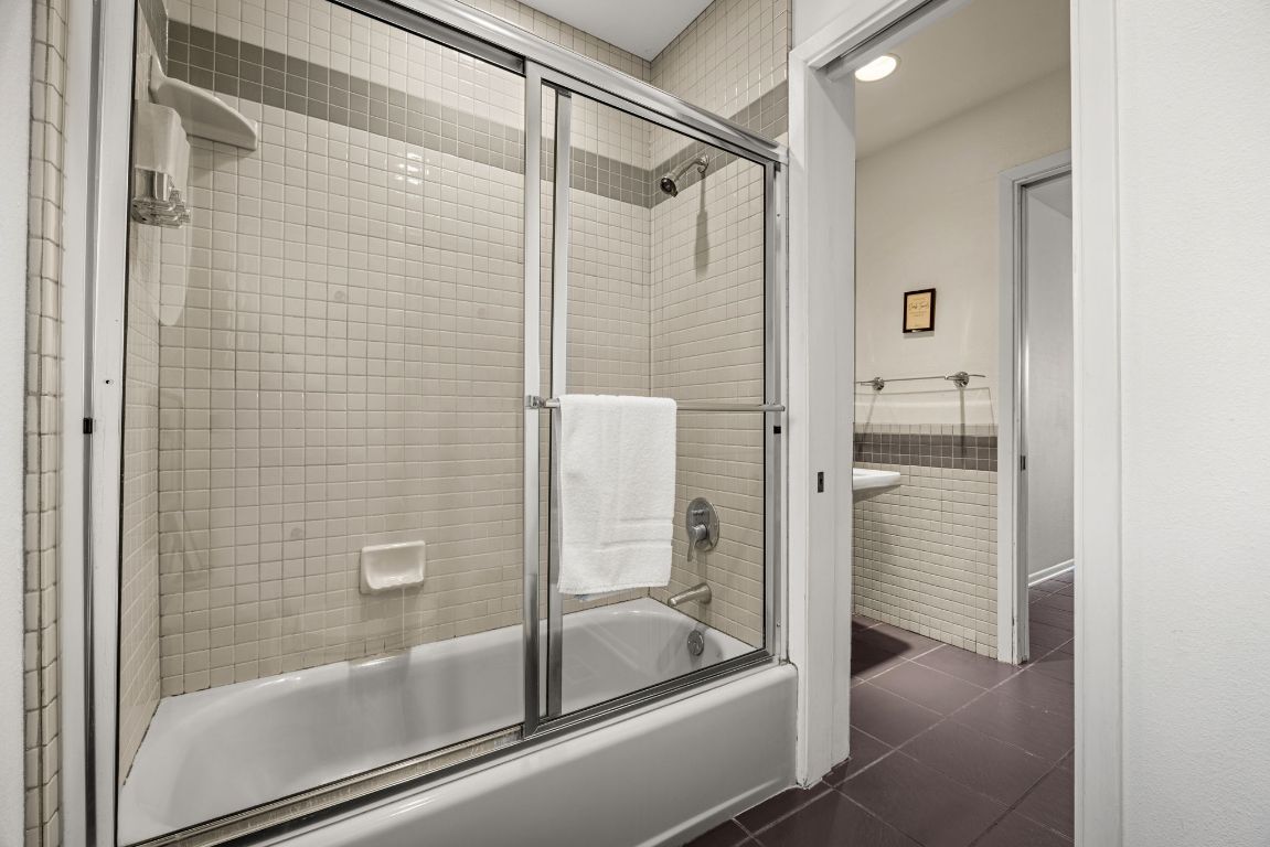 723 Coventry Road Spicewood, TX 78669 - Photo 22 of 40 a bathroom with a glass shower door