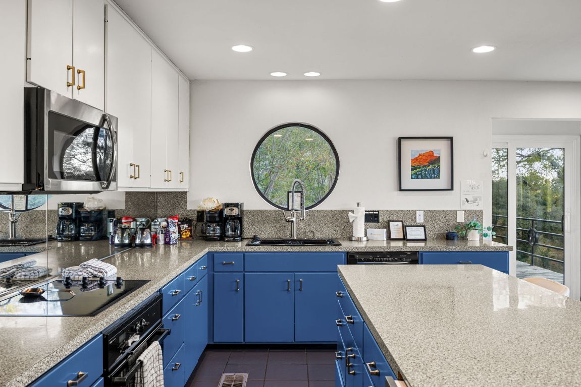 723 Coventry Road Spicewood, TX 78669 - Photo 6 of 40 a kitchen with a sink and cabinets