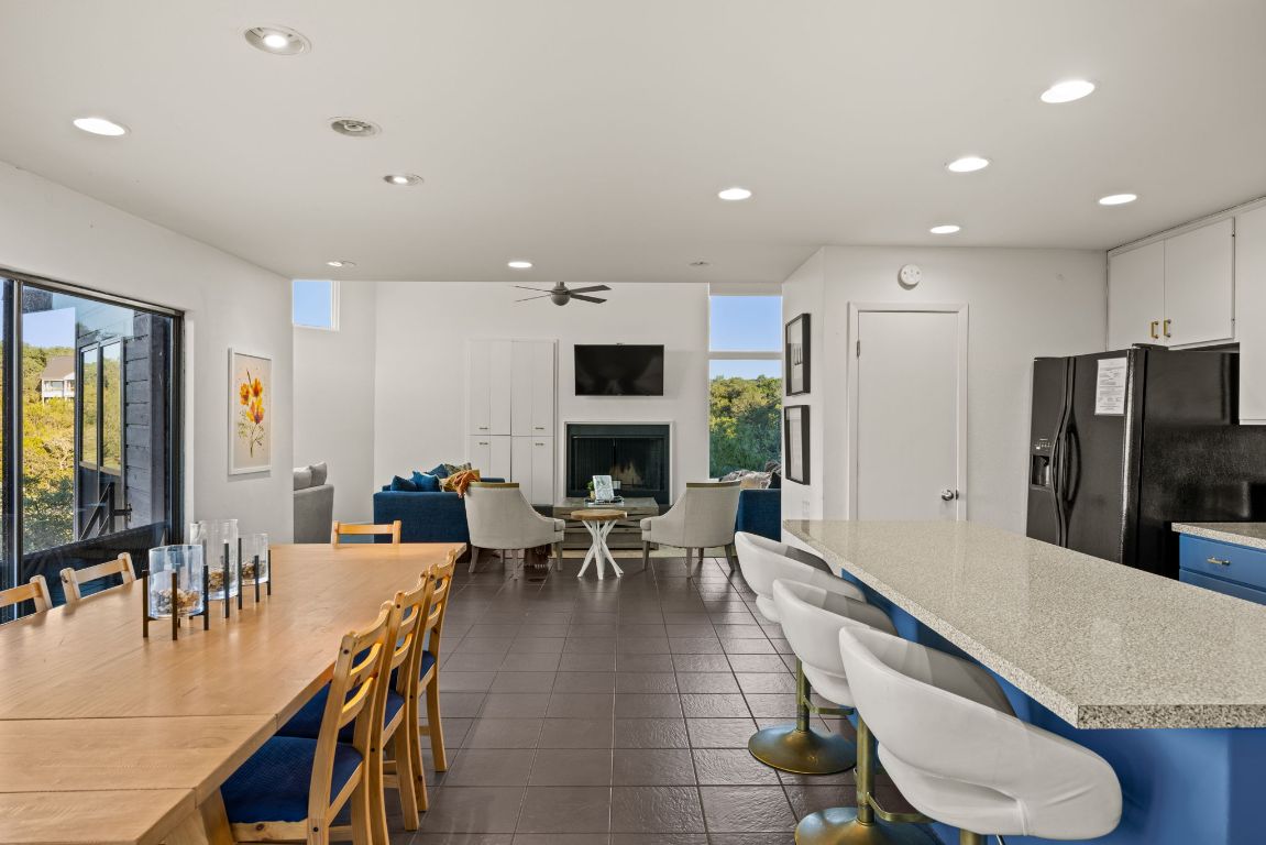 723 Coventry Road Spicewood, TX 78669 - Photo 9 of 40 an open kitchen with dining table and stainless steel appliances