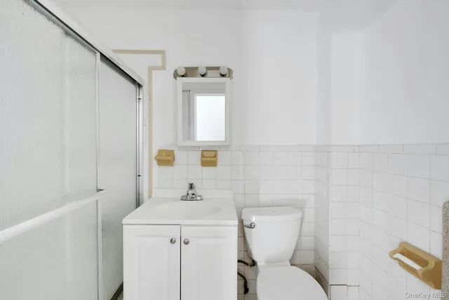 a bathroom with a sink a toilet and mirror