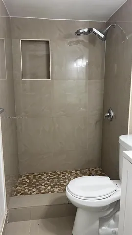 a bathroom with a toilet and a shower