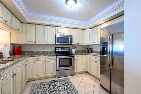 a kitchen with stainless steel appliances granite countertop a sink and cabinets
