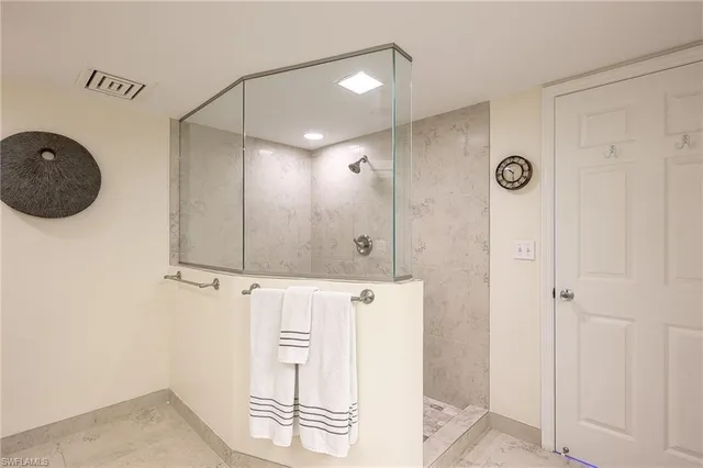 a bedroom with a bed chandelier and a window