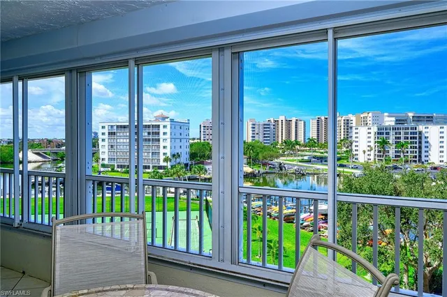 a view of a bedroom with furniture and a large window