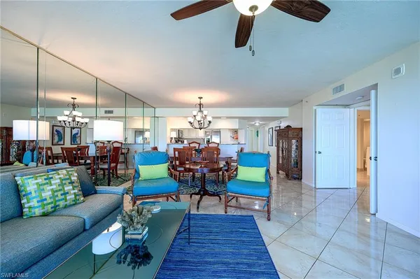 a living room with furniture and a chandelier