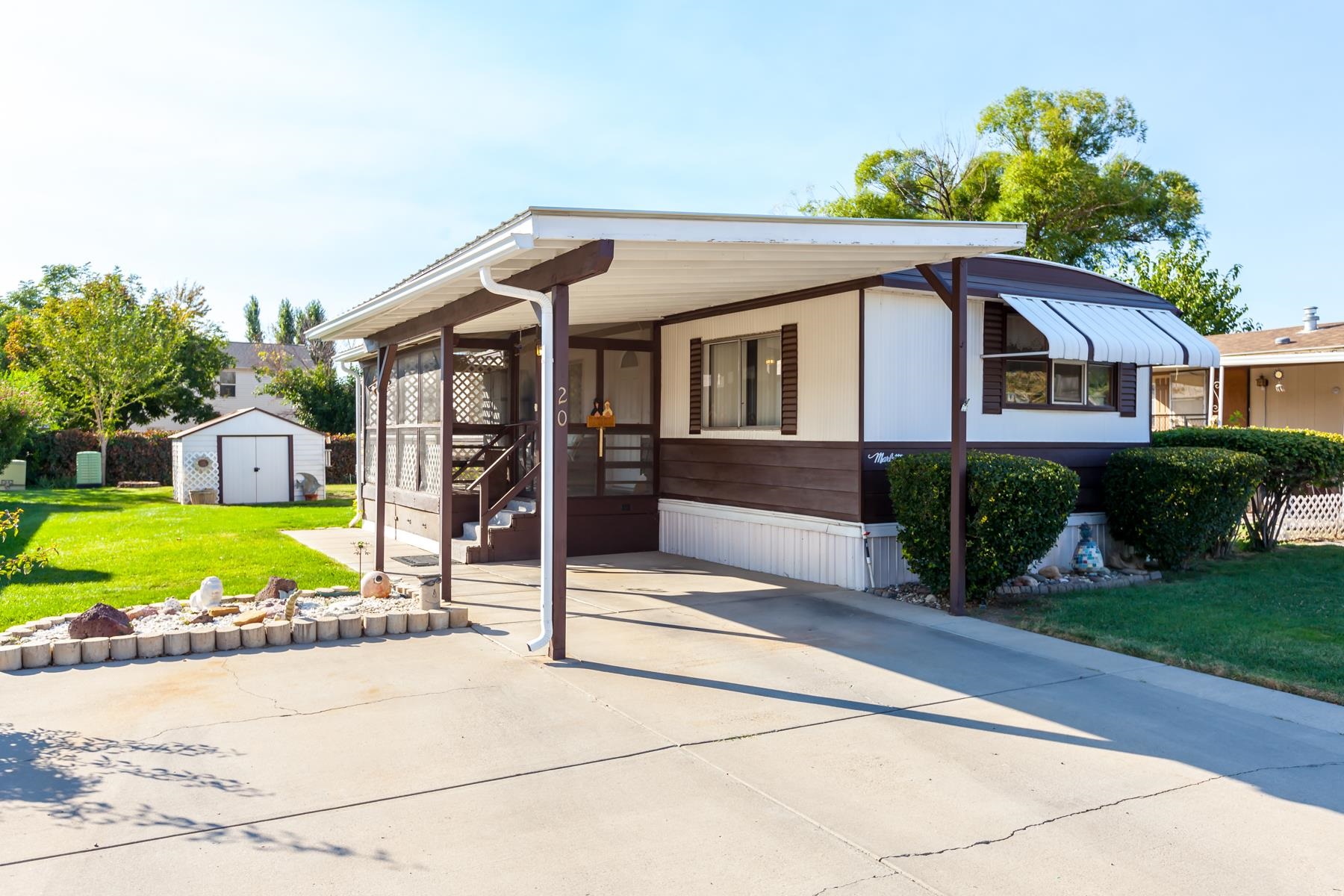 3251 E Road, Unit 20 Clifton, CO 81520 - Photo 1 of 26 a front view of a house with a garden and trees