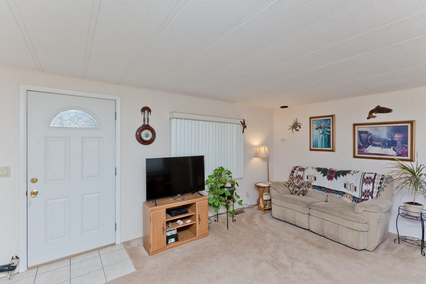 3251 E Road, Unit 20 Clifton, CO 81520 - Photo 14 of 26 a living room with furniture and a flat screen tv