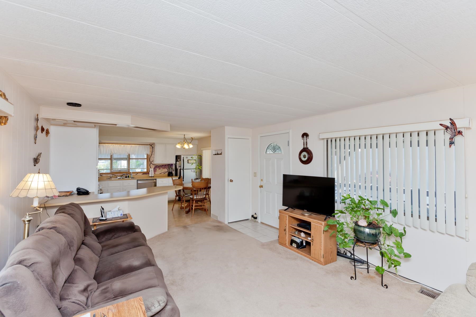 3251 E Road, Unit 20 Clifton, CO 81520 - Photo 16 of 26 a living room with furniture and a flat screen tv