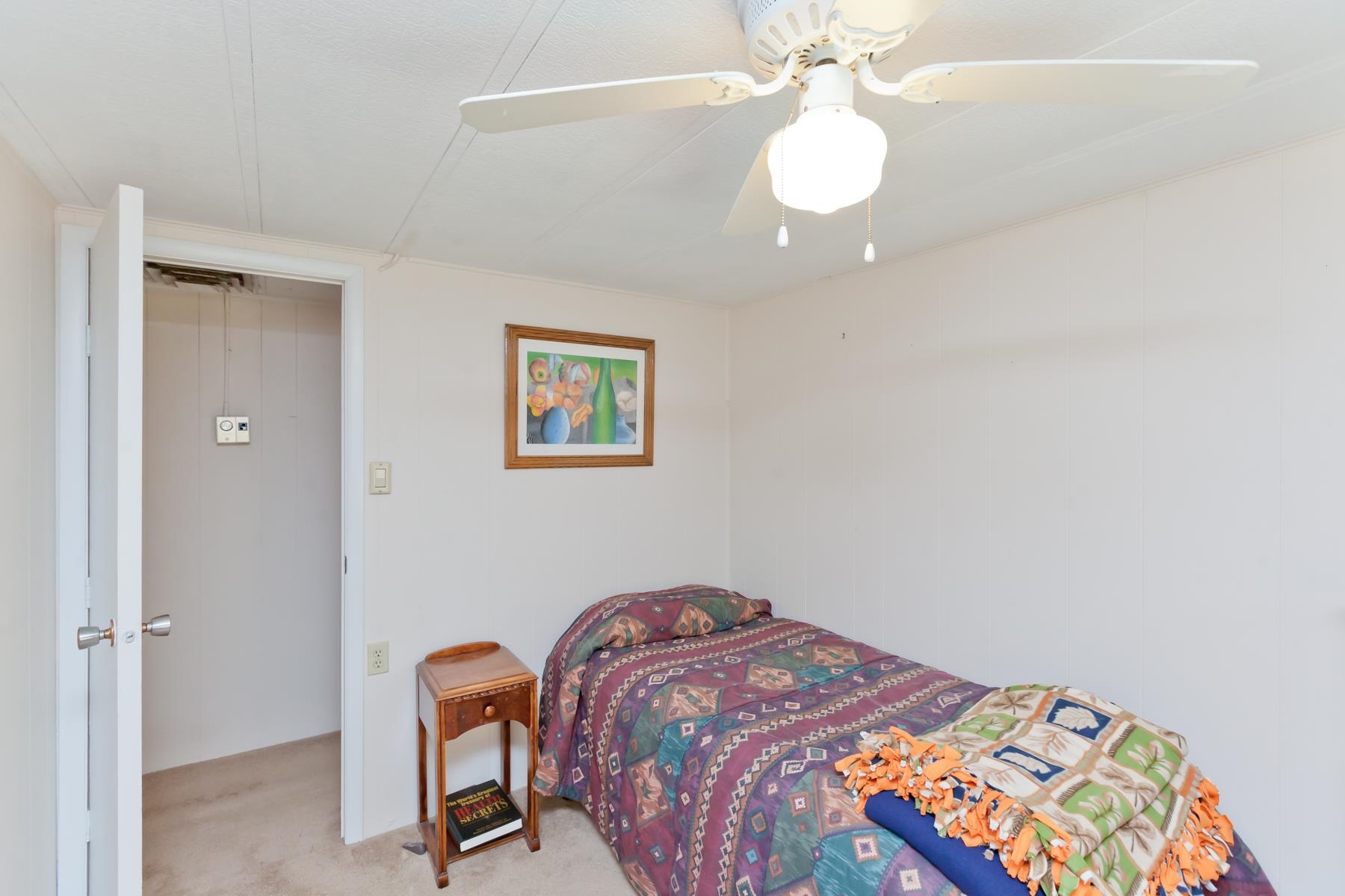 3251 E Road, Unit 20 Clifton, CO 81520 - Photo 18 of 26 a bedroom with a bed and a chandelier