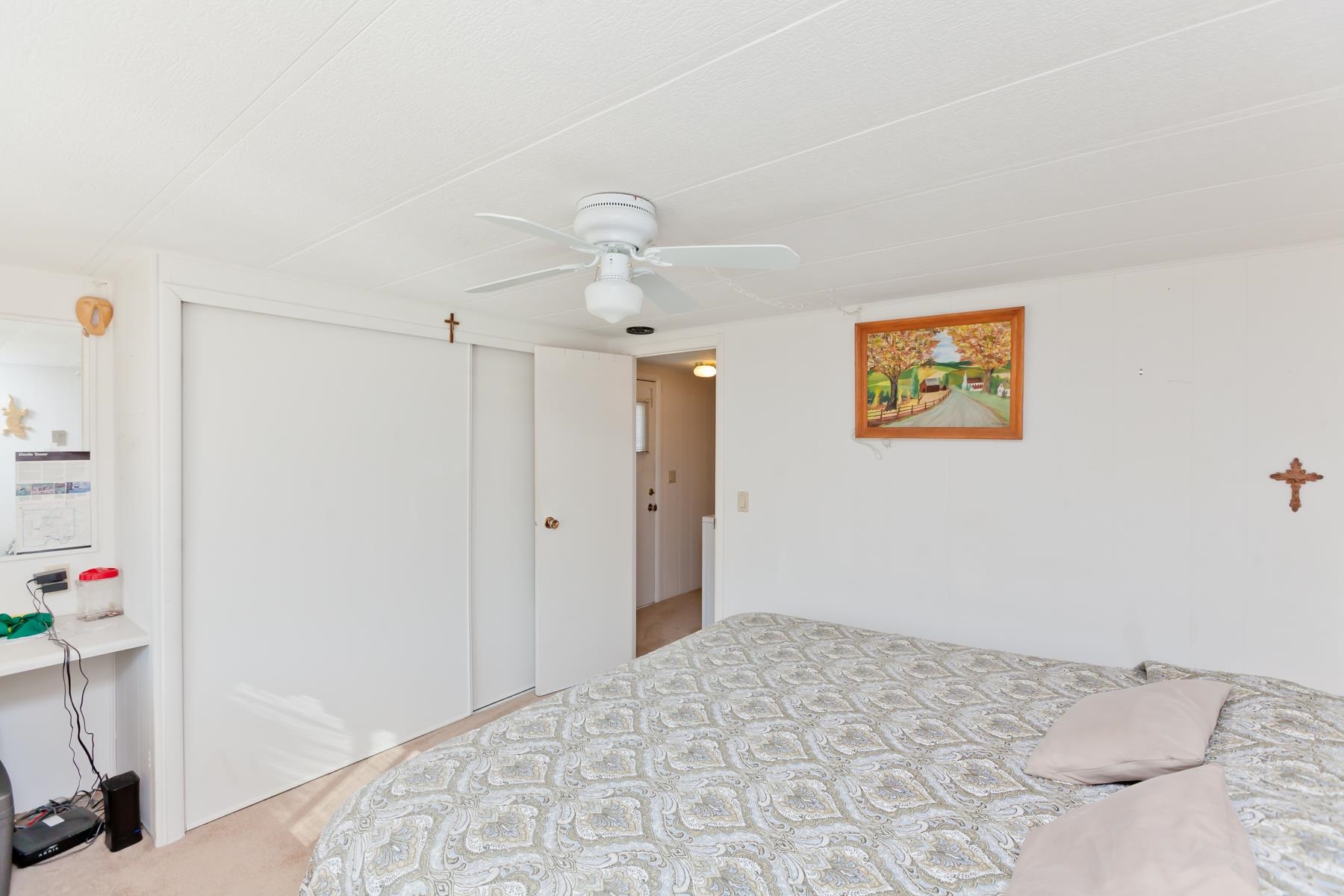 3251 E Road, Unit 20 Clifton, CO 81520 - Photo 25 of 26 a bedroom with a bed and a chandelier