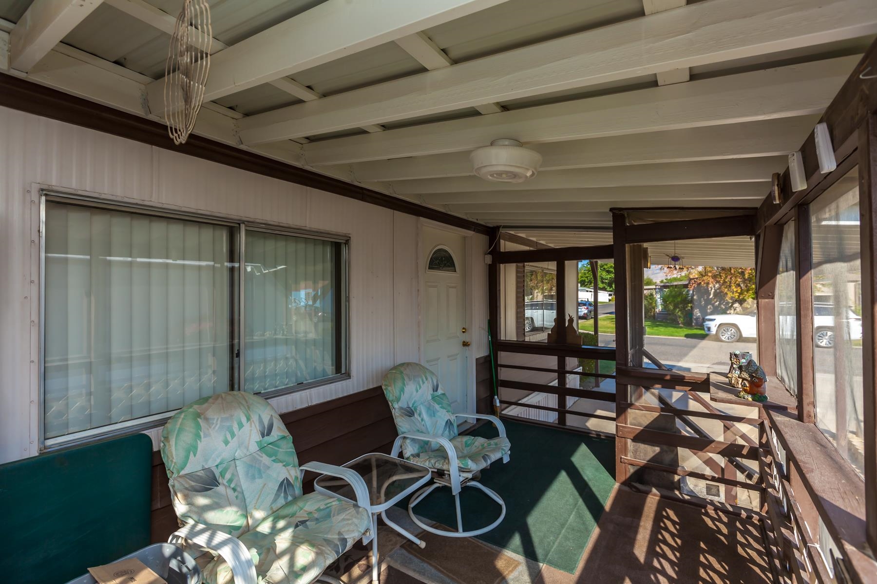 3251 E Road, Unit 20 Clifton, CO 81520 - Photo 7 of 26 a living room with furniture and a floor to ceiling window