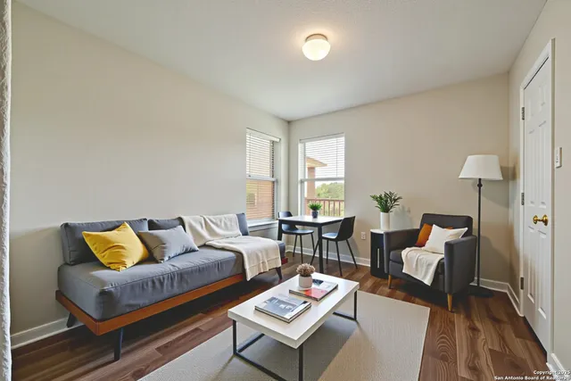 a living room with furniture and wooden floor