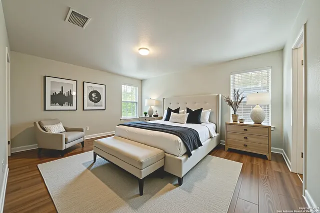 a bedroom with a bed and wooden floor