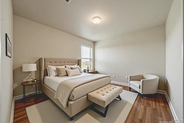 a bedroom with a bed and a night stand