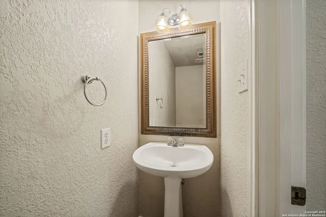 a bathroom with a sink and mirror