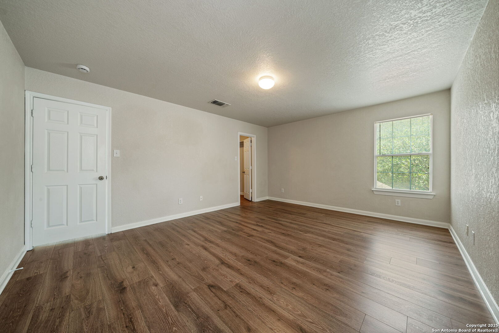4731 Bending Grove San Antonio, TX 78259 - Photo 28 of 43 an empty room with wooden floor and windows