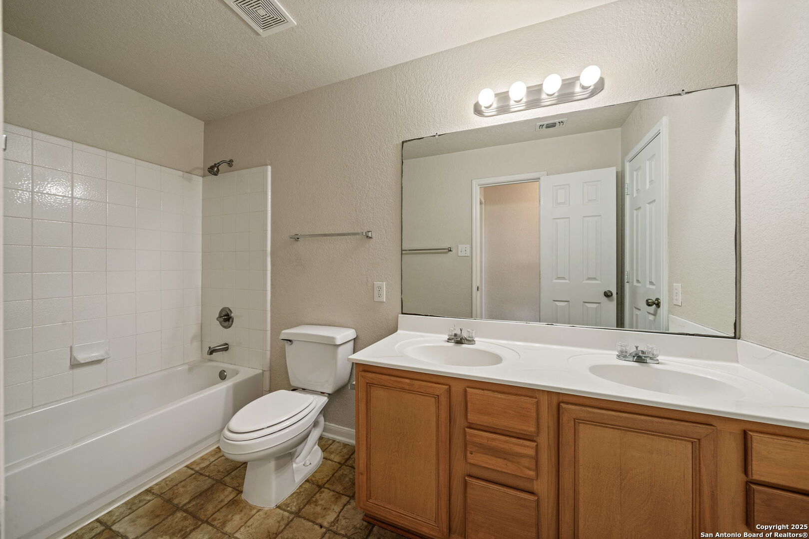 4731 Bending Grove San Antonio, TX 78259 - Photo 32 of 43 a spacious bathroom with a sink a toilet a large mirror and shower