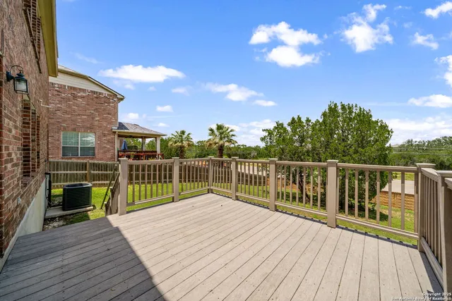 a balcony with filled with wooden floor