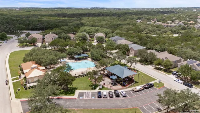 an aerial view of multiple houses with yard