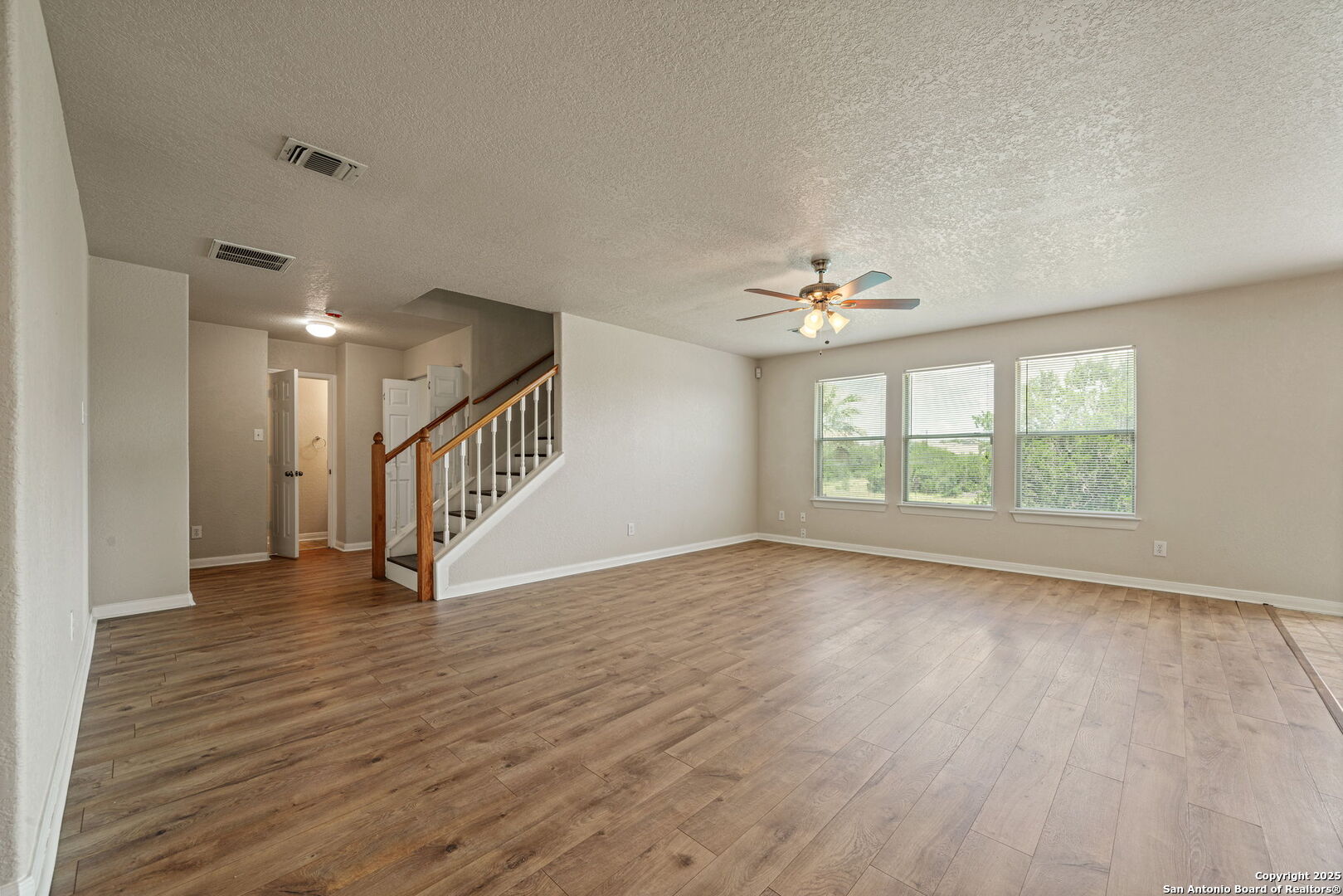 4731 Bending Grove San Antonio, TX 78259 - Photo 7 of 43 a view of an empty room with wooden floor and a window
