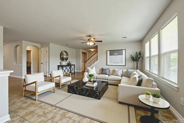 a living room with furniture and a large window