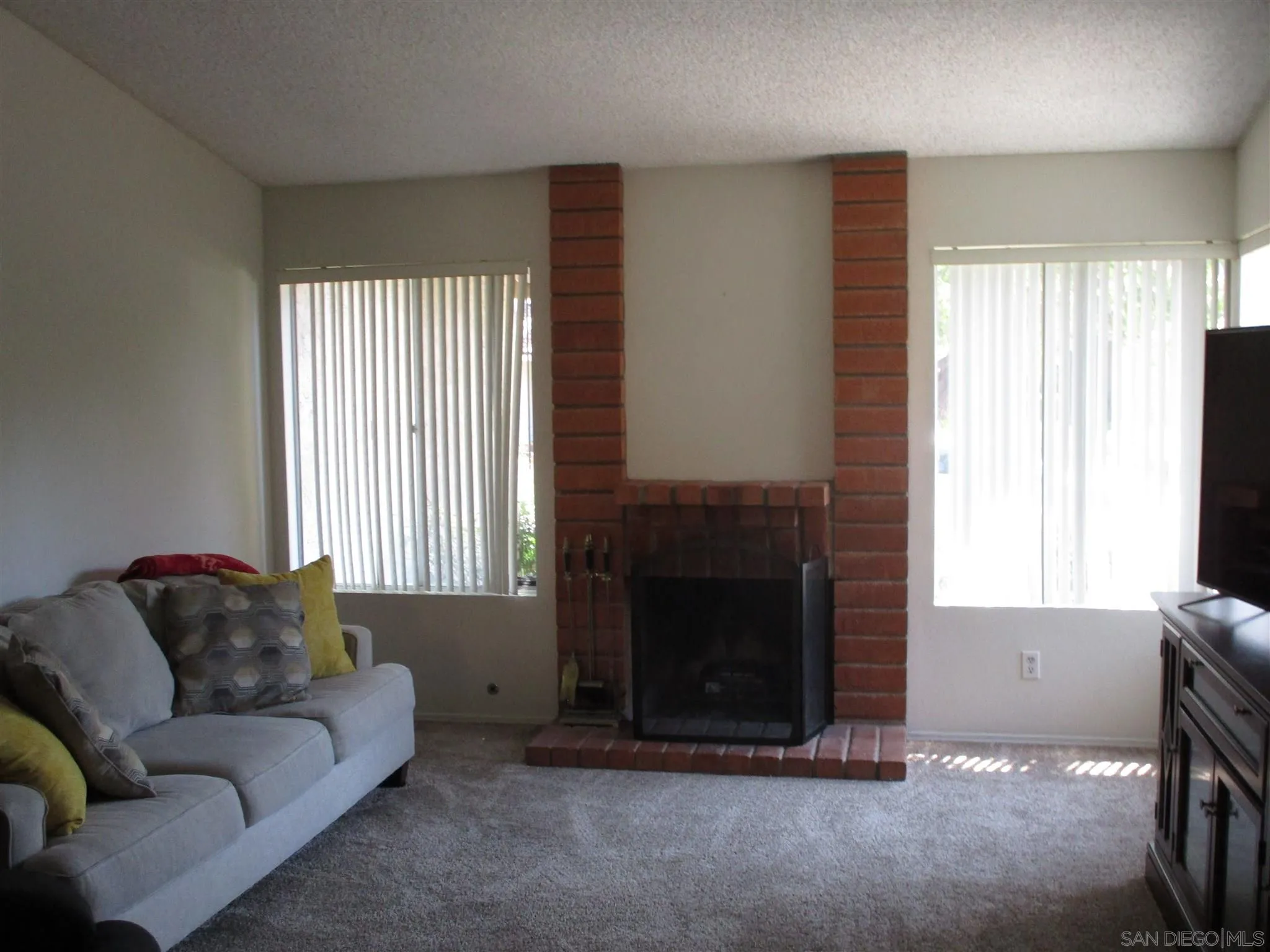 10528 Moorpark Street Spring Valley, CA 91978 - Photo 2 of 3 a living room with furniture and a fireplace
