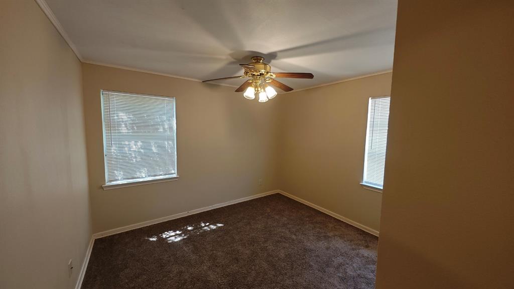 12225 Schroeder Road Dallas, TX 75243 - Photo 29 of 40 Carpeted flooring, two windows with blinds, ceiling fan with integrated lighting, and neutral wall tones