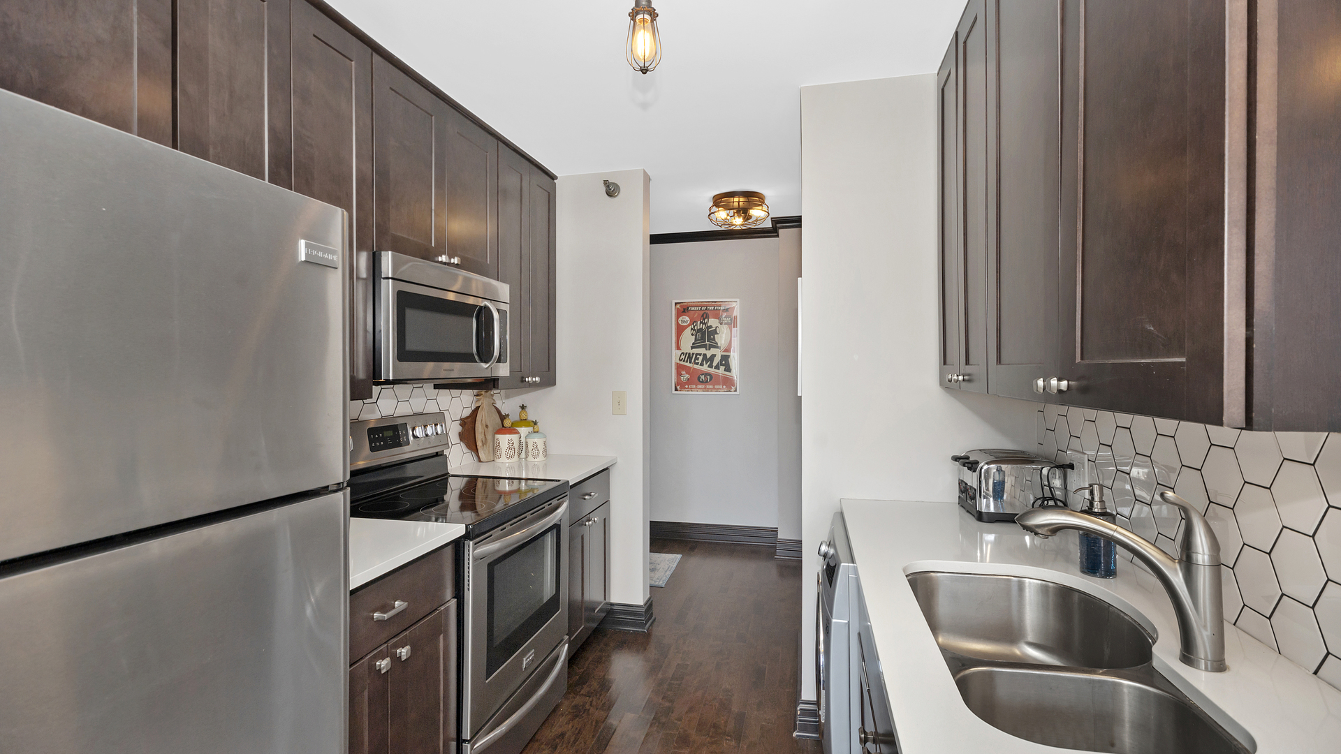 1122 North Clark Street, Unit 3808 Chicago, IL 60610 - Photo 11 of 29 a kitchen with stainless steel appliances granite countertop a sink stove and refrigerator