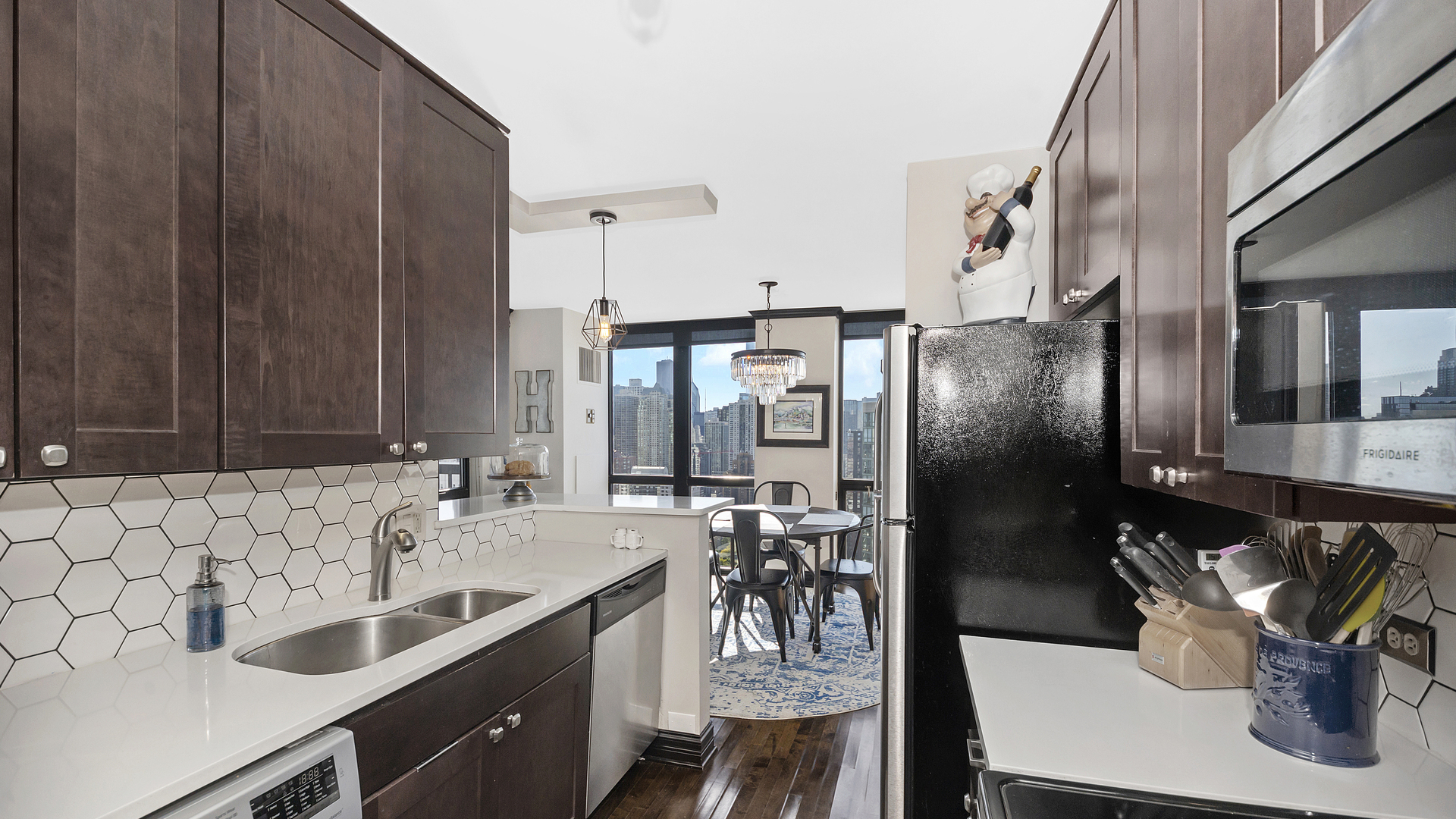 1122 North Clark Street, Unit 3808 Chicago, IL 60610 - Photo 12 of 29 a kitchen with a sink refrigerator and cabinets