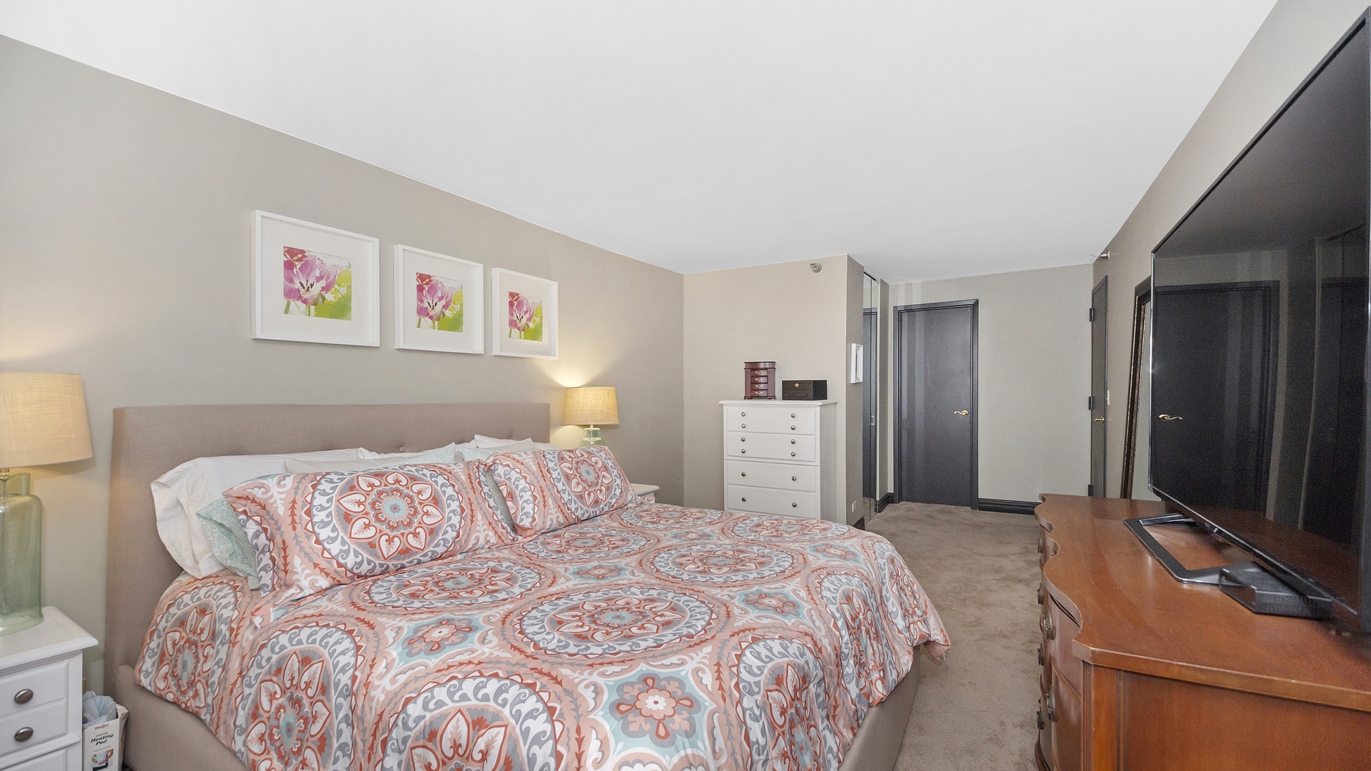 1122 North Clark Street, Unit 3808 Chicago, IL 60610 - Photo 15 of 29 a bedroom with a bed and a flat screen tv