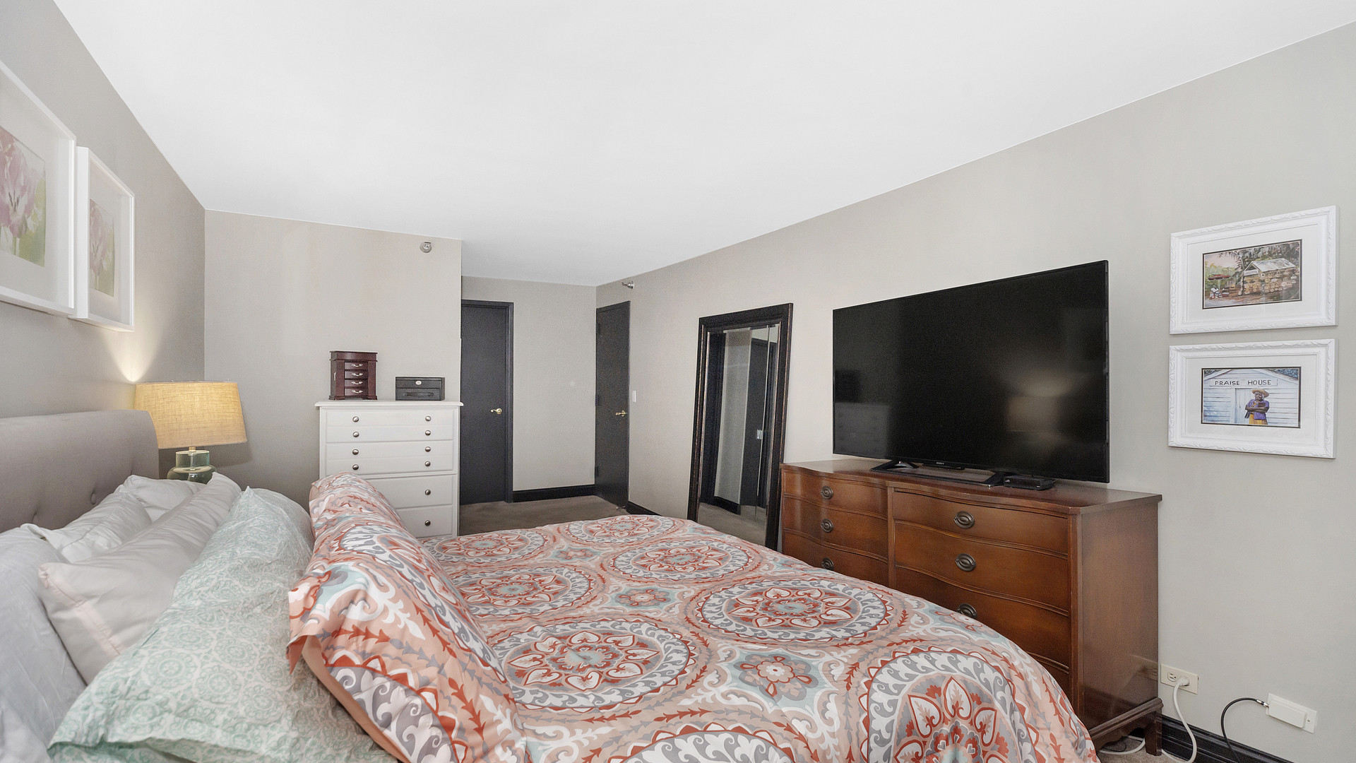1122 North Clark Street, Unit 3808 Chicago, IL 60610 - Photo 16 of 29 a bedroom with a bed and a flat screen tv