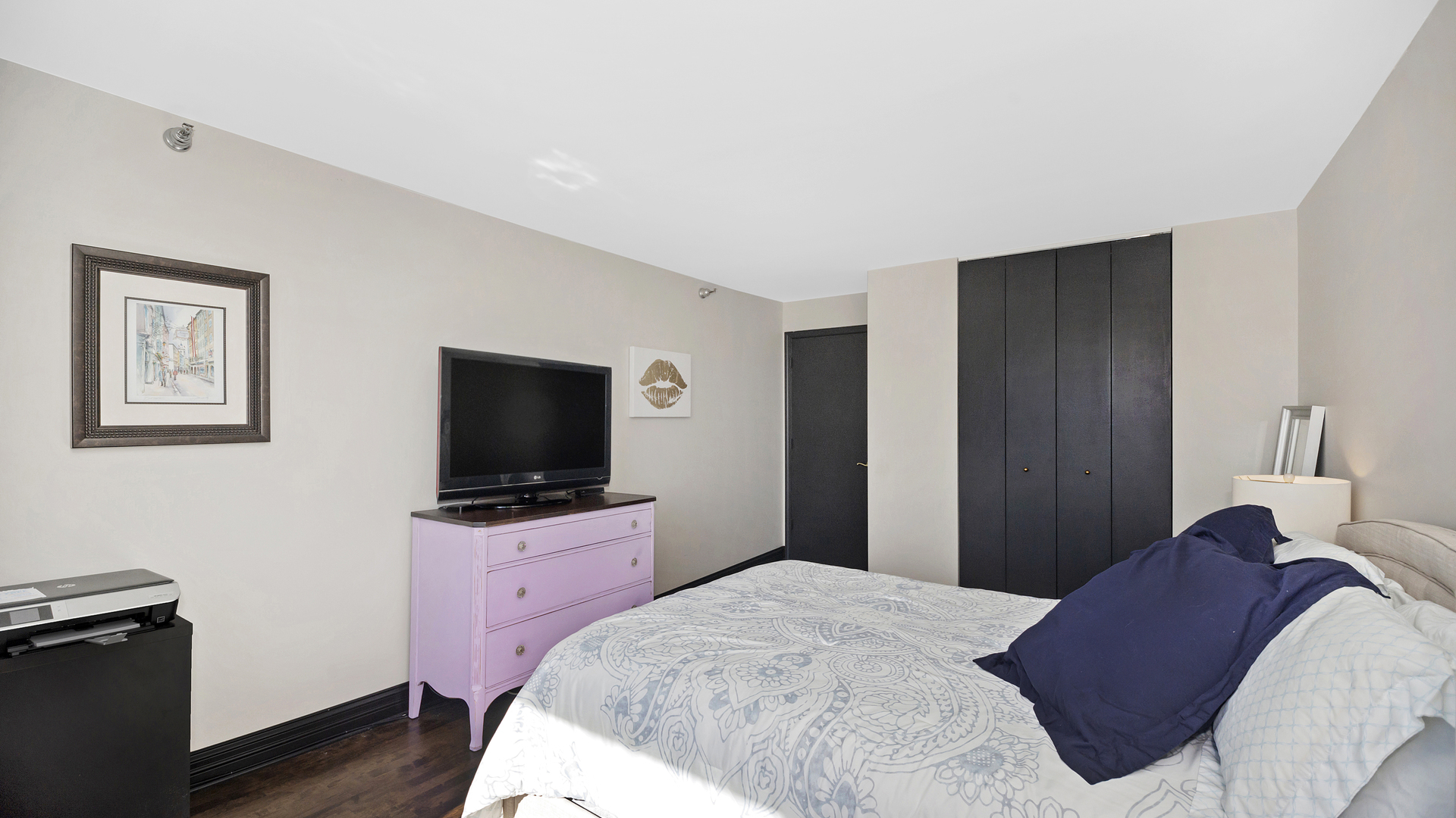 1122 North Clark Street, Unit 3808 Chicago, IL 60610 - Photo 19 of 29 a bedroom with a bed and a flat screen tv