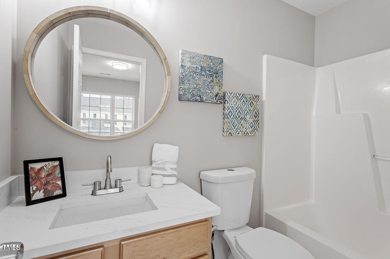 5340 Big Bass Drive Raleigh, NC 27610 - Photo 19 of 20 a white toilet sitting next to a bathroom sink