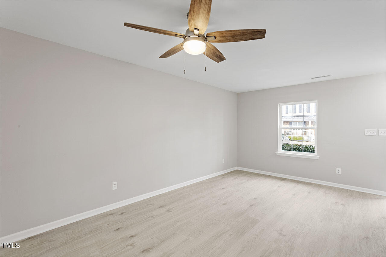 5340 Big Bass Drive Raleigh, NC 27610 - Photo 4 of 20 an empty room with a window and a fan