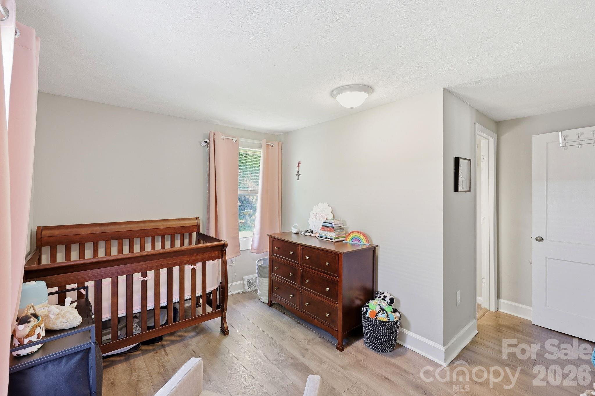 197 Mulberry Street Clyde, NC 28721 - Photo 18 of 31 a bedroom with furniture and a window