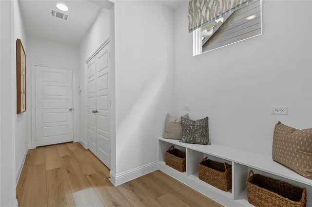 a view of a bedroom with furniture and wooden floor