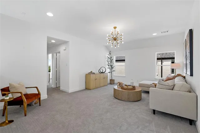 a living room with furniture a chandelier and a couch