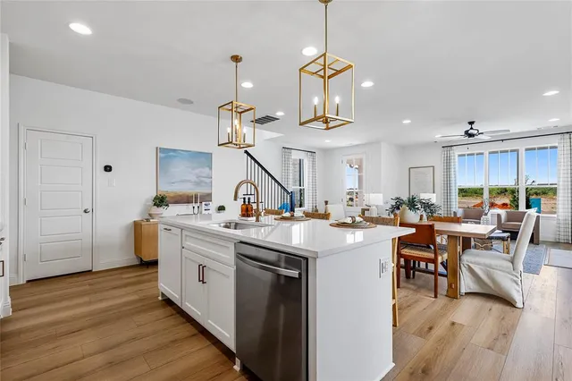 a kitchen with lots of counter top space and wooden floor