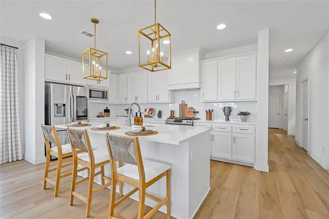 a kitchen with cabinets a sink and appliances