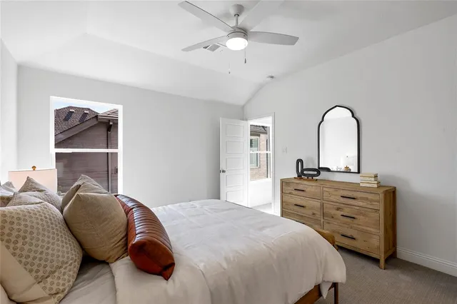 a bedroom with a bed and a dresser with closet