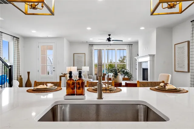 a kitchen with sink a large mirror and cabinets