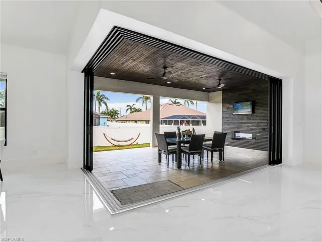 a view of a dining room with furniture and chandelier