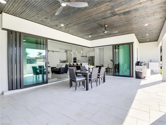 a view of a patio with table and chairs