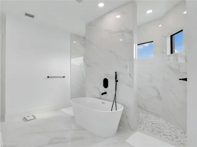 a bed sitting in a bedroom next to a lamp