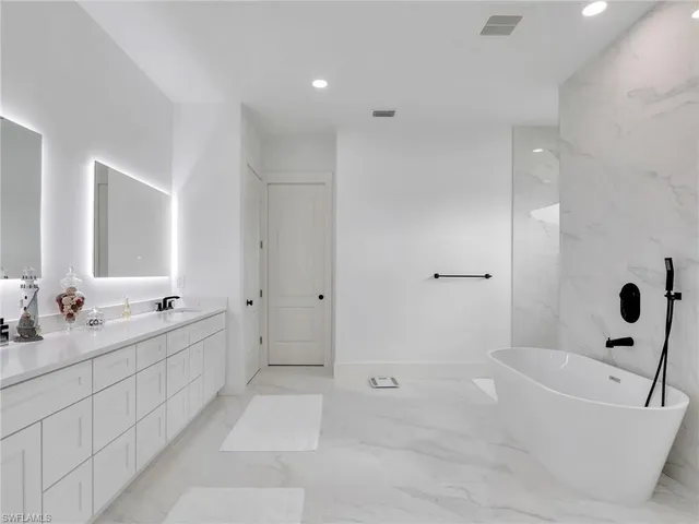 a bathroom with a bathtub and shower