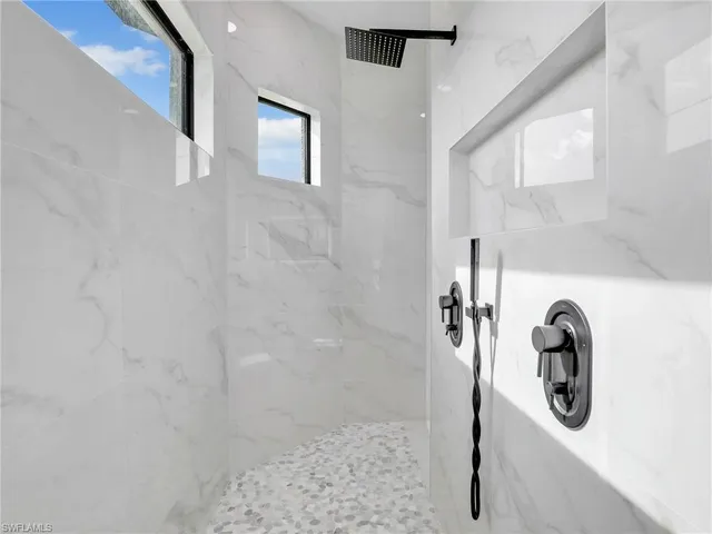 a bathroom with a tub a sink and mirror