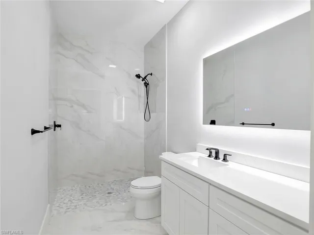 a view of walk in closet with clothes